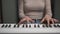 Unrecognizable young woman practicing in playing piano