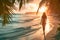 Unrecognizable young woman walking along the shore of a tropical beach at sunset. Travel and vacation concept