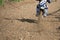 Unrecognized athlete riding a sports motorbike on a motocross racing