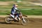 Unrecognized athlete riding a sports motorbike on a motocross racing