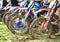 Unrecognized athletes riding a sports motorbike and muddy wheel on a motocross racing event