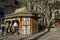 Unrecognized passerby do some shopping at a kiosk with newspaper and magazines, in Antonio Prado Square