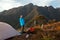 Unrecognized people enjoying the mountain landscape view from a mountain camping