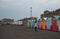 Unrecognized people walking and exercising on coastal path near beach huts in Brighton sussex United Kingdom