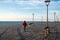 Unrecognized person walking on wooden pier at sea. Limassol Cyprus