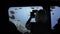 An unrecognized silhouette of tourists on an underwater ship is studying, viewing and photographing a flock of colorful