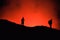 Unrecognized Tourists`s silhouettes on Erta Ale Volcano edge
