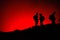 Unrecognized Tourists`s silhouettes on Erta Ale Volcano edge