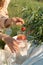 Unrecognized woman making a refreshing drink from strawberries at a picnic.