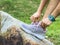 Unrecognized Woman Tying shoelace in nature park. Selective focus. Sports/Outdoor concept with copy space