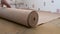 Unroll Natural Cork roll on the floor. basis for a Laminate