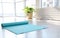 Unrolled light blue yoga mat on floor