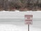 Unsafe ice sign on frozen lake