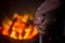 Unsafe worker hands. A local steel machine parts making yard worker melting scrap on hot furnace