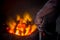 Unsafe worker hands. A local steel machine parts making yard worker melting scrap on hot furnace