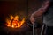 Unsafe worker hands. A local steel machine parts making yard worker melting scrap on hot furnace