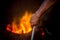 Unsafe worker hands. A local steel machine parts making yard worker melting scrap on hot furnace