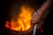 Unsafe worker hands. A local steel machine parts making yard worker melting scrap on hot furnace