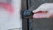 Unscrewing the old blockage lock on the iron door of the black garage. Protection against intrusion and theft, close-up