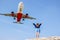 Unseen Phuket, the beach for viewing planes landing at near Phuket International Airport, happy fun woman and flying aircraft.