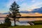 Unset view of Jezioro Selmet Wielki lake landscape with vintage pier, reeds and shoreline in Sedki in Masuria region of Poland