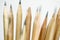 Unsharpened pencil in focus on beam of natural wood pencils