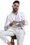 Unshaved fashion guy in white suit taking glasses off and posing
