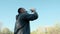 Unshaven man drinks water from an outdoor plastic bottle. Quenching thirst