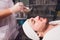 Unshaven man having cosmetic mask in spa salon, top view.