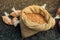 Unshelled peanuts in a straw sack on display