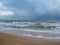 The unsurpassed beauty of the sea coast against the background of rain clouds during a thunderstorm.