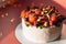 Unsweetened mushroom cake topped with curd cheese garnished with vegetables and salami in front of the lights