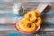 Unsweetened round cheese biscuits with herbs and almonds on a ceramic spoon on a wooden background. Savory cookie recipes as