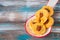 Unsweetened round cheese biscuits with herbs and almonds on a ceramic spoon on a wooden background. Savory cookie recipes as