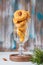 Unsweetened round cheese cookies with herbs and fried almonds in a glass glass on a wooden background. Savory cookie recipes as