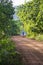 An untarred rural road with smoky motorcycle