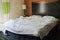 Untidy bed in hotel bedroom