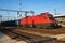 Untitled cargo train locomotive at railway train station. Platform track view. International freight. Cargo shipping