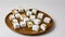 Untoasted And Lightly Toasted Marshmallows Arranged Neatly On A Round Wooden Plate