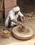 Untouchable Caste Indian Man at Pottery Wheel with Many Pots
