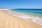 untouched sand dune beach alongside clear ocean waters