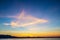 Unusal but beautiful sunset over Lake Tahoe with whispy triange shape in sky and swirls near horizon