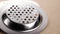 Unused kitchen sink strainer. Shiny stainless steel filter with holes