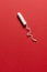 Unused Tampon on a Red Background with Copy Space