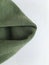 Unusual abstract background. Minimalism. Green crumpled hoodie.