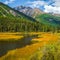 Unusual beautiful lake in highland valley and river along high mountain. Swampy backwater of mountain lake. Yellow atmospheric