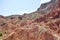 Unusual beautiful nature of the canyon in Kyrgyzstan. Red mountains against the blue sky.