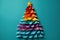 An unusual Christmas tree made of paper on a blue background. Festive mood and expectation of a miracle