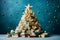 An unusual Christmas tree from a variety of books decorated with a variety of decor on a blue background