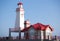 Unusual colorful lighthouse with keeper\'s house